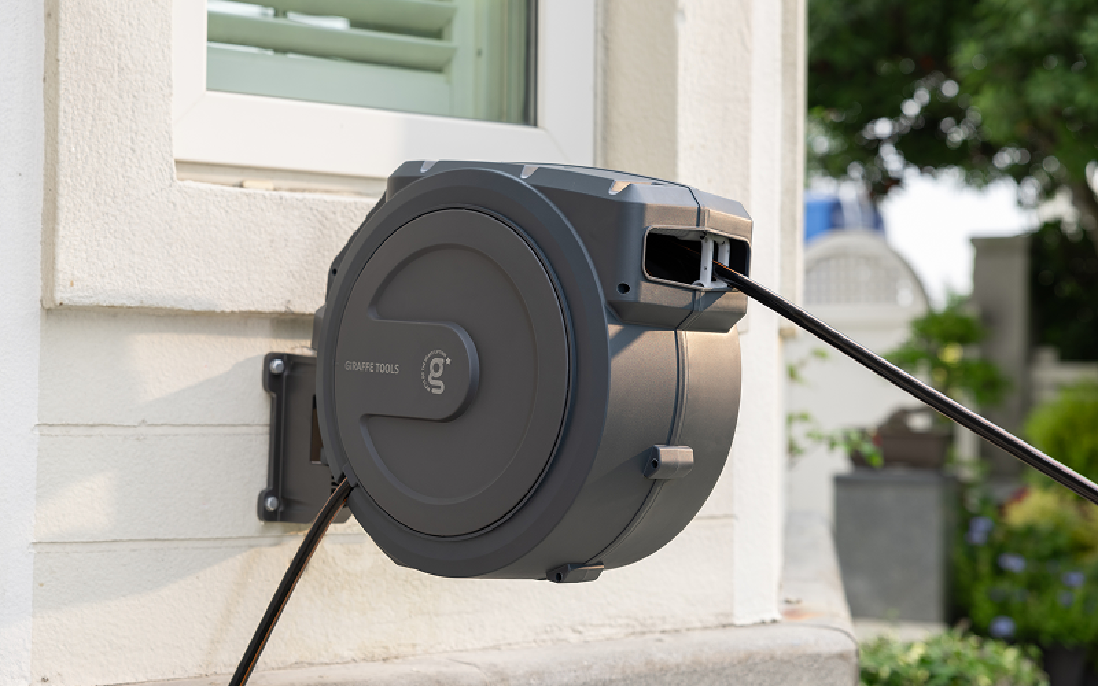 Retractable garden hose stored neatly on its reel